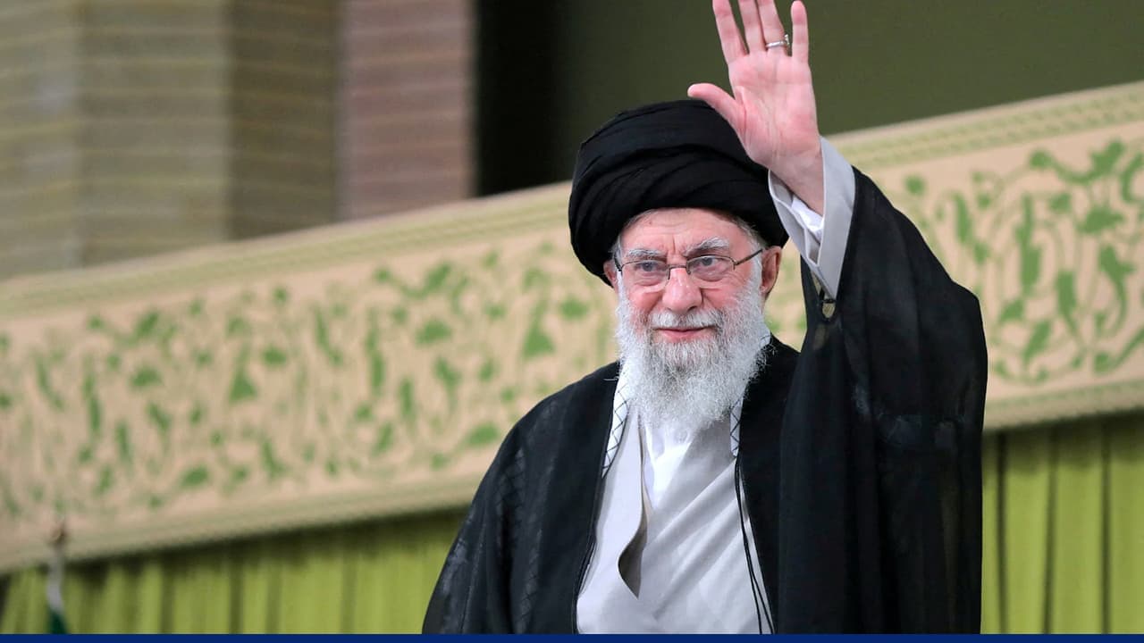 Ayatollah Ali Khamenei raising hand during public appearance