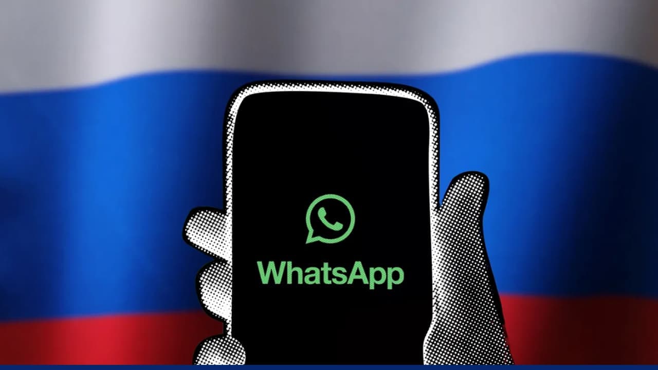 Smartphone displaying WhatsApp logo against Russian flag background