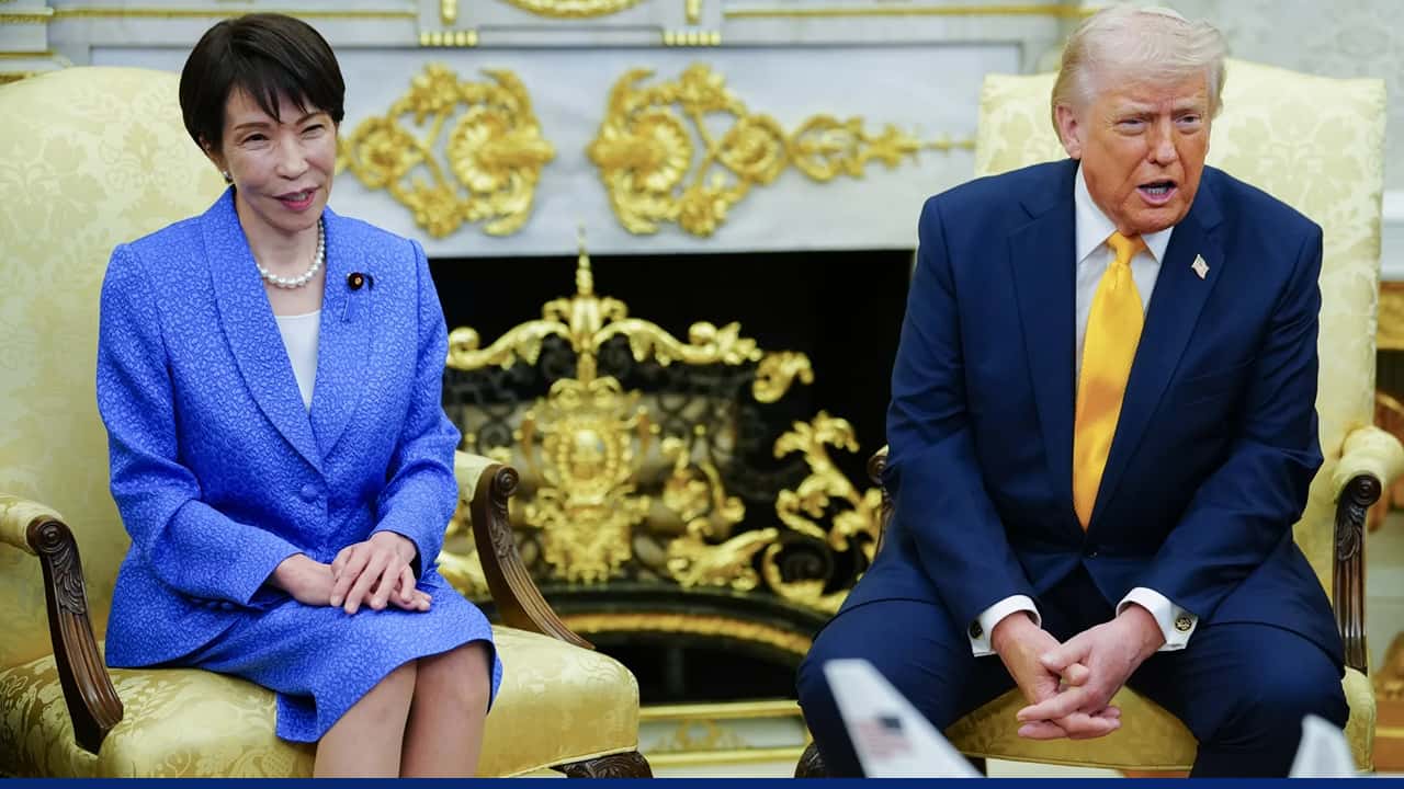 Sanae Takaichi meets with Donald Trump during a formal discussion, seated in an ornate room with gold-accented décor.