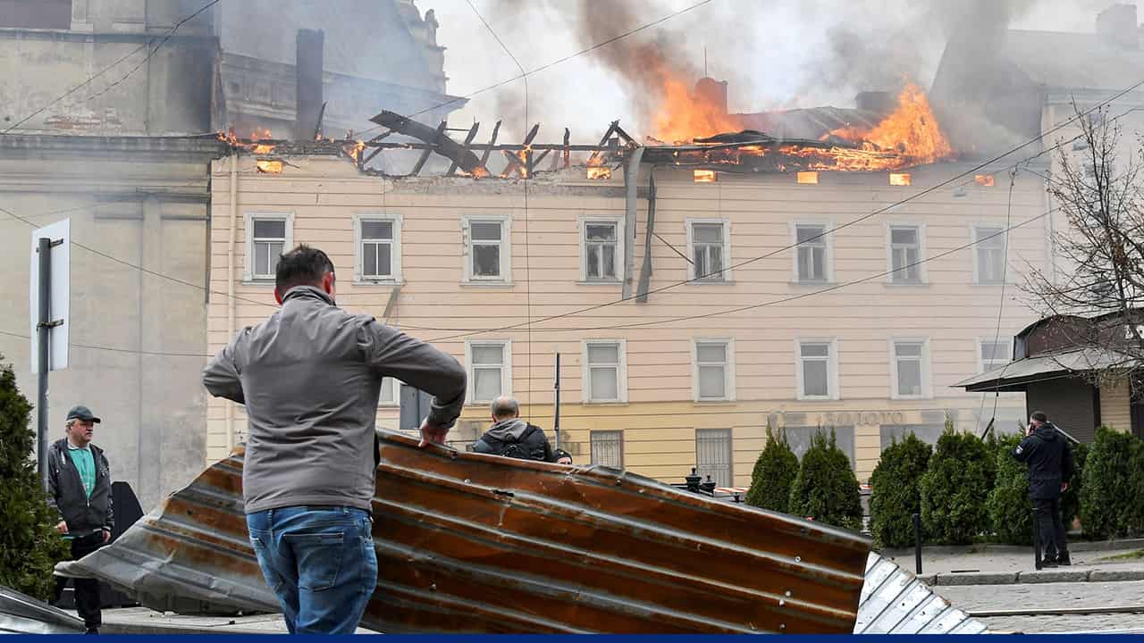 A partially obscured scene showing people handling debris near a damaged structure, with glitch-like overlays and fragmented text covering much of the image.