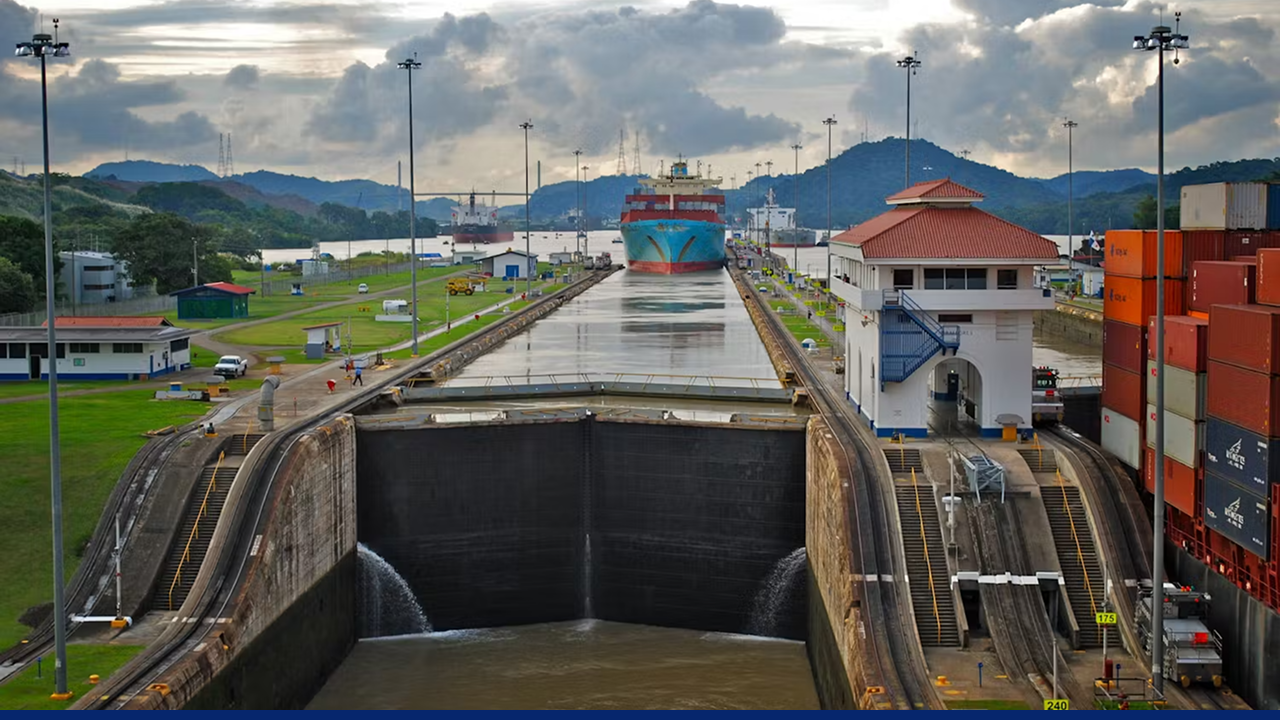 A container ship transits through the Panama Canal's lock system, an essential engineering feat that enables global maritime trade by connecting the Atlantic and Pacific Oceans